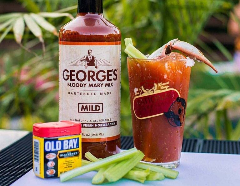 GEORGE’S® Mild Bloody Mary mix bottle with OLD BAY®, Bloody Mary in Natty Boh glass, and celery sticks