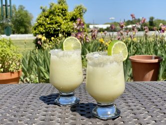 2 GEORGE’S® Coconut Margaritas on outside table