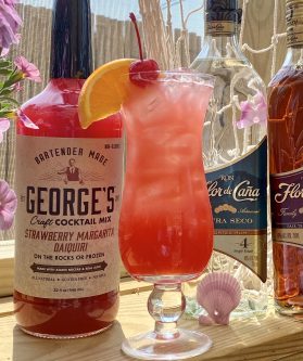 GEORGE’S® Rum Punch served with cherry and orange slice garnish