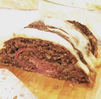 sliced GEORGE’S® Meatloaf with Bloody Mary Sauce on cutting board