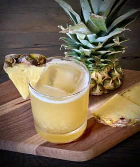 GEORGE’S® Pineapple Sour served with pineapple wedge garnish