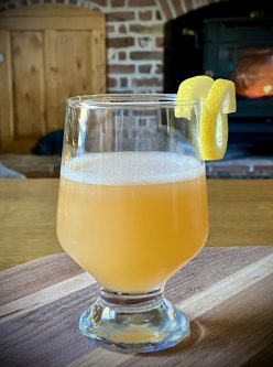 GEORGE’S® Wintery Citrus Sour served in glass with lemon rind garnish