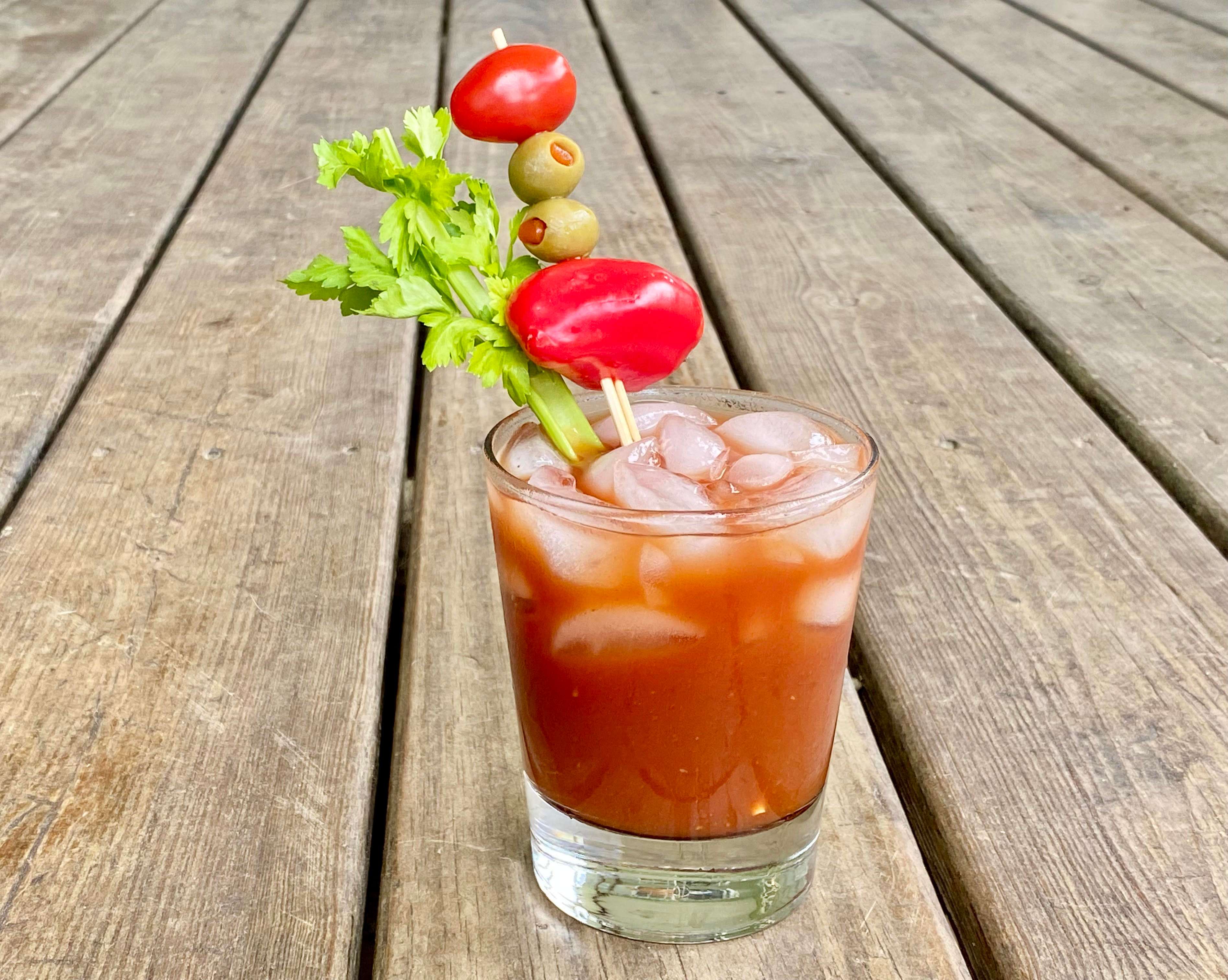 bloody mary cocktail with celery olives and tomatoes