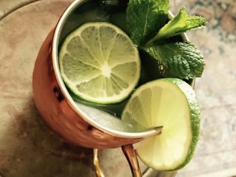GEORGE’S® Irish Mule served in copper mug with lime slices and mint sprigs for garnish