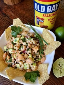 GEORGE'S® Ceviche served with chips in a bowl next to GEORGE'S® OLD BAY® Bloody Mary Mix
