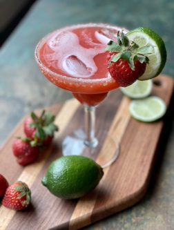 GEORGE’S® Strawberry Margarita served in salt rimmed glass