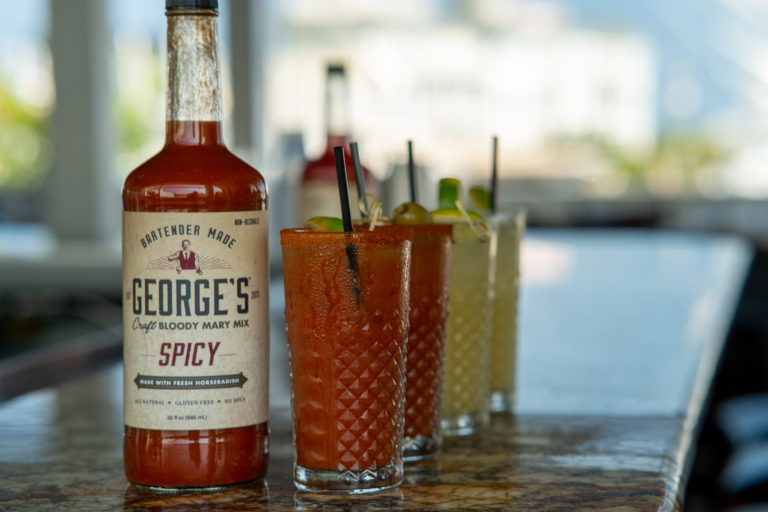 GEORGE’S® Spicy Bloody Mary Mix with glasses next to the mix.