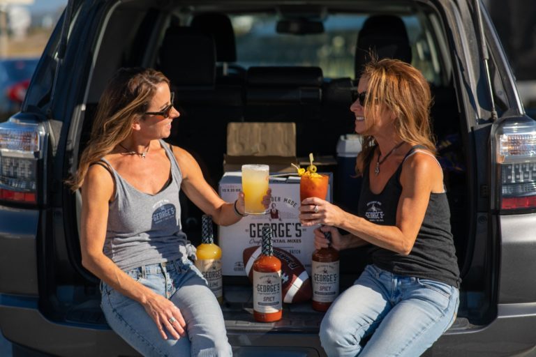 girls sitting on back of 4runner drinking george's cocktails