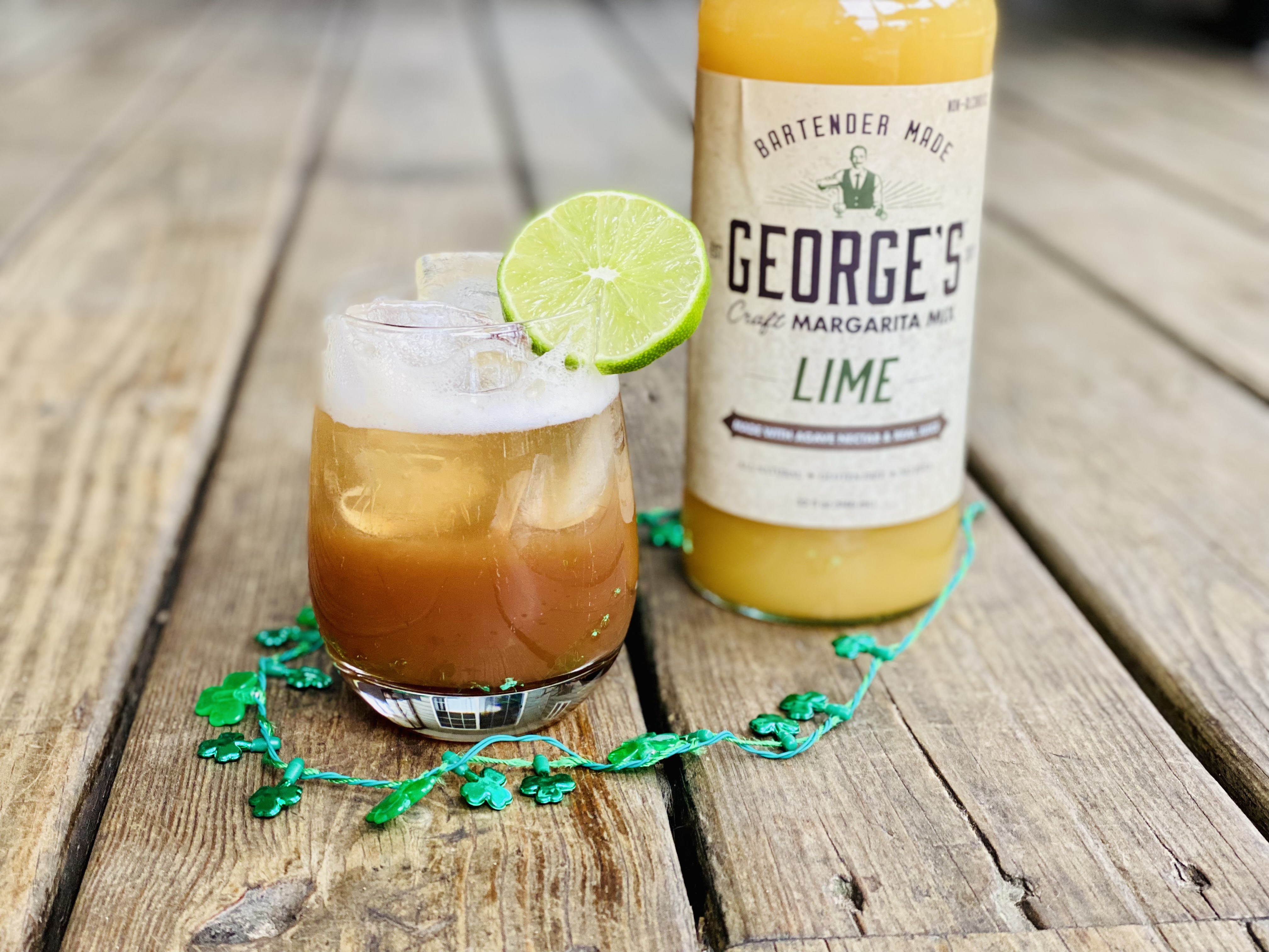GEORGE'S Irish Rose cocktail with green shamrock beads and GEORGE'S lime margarita mix