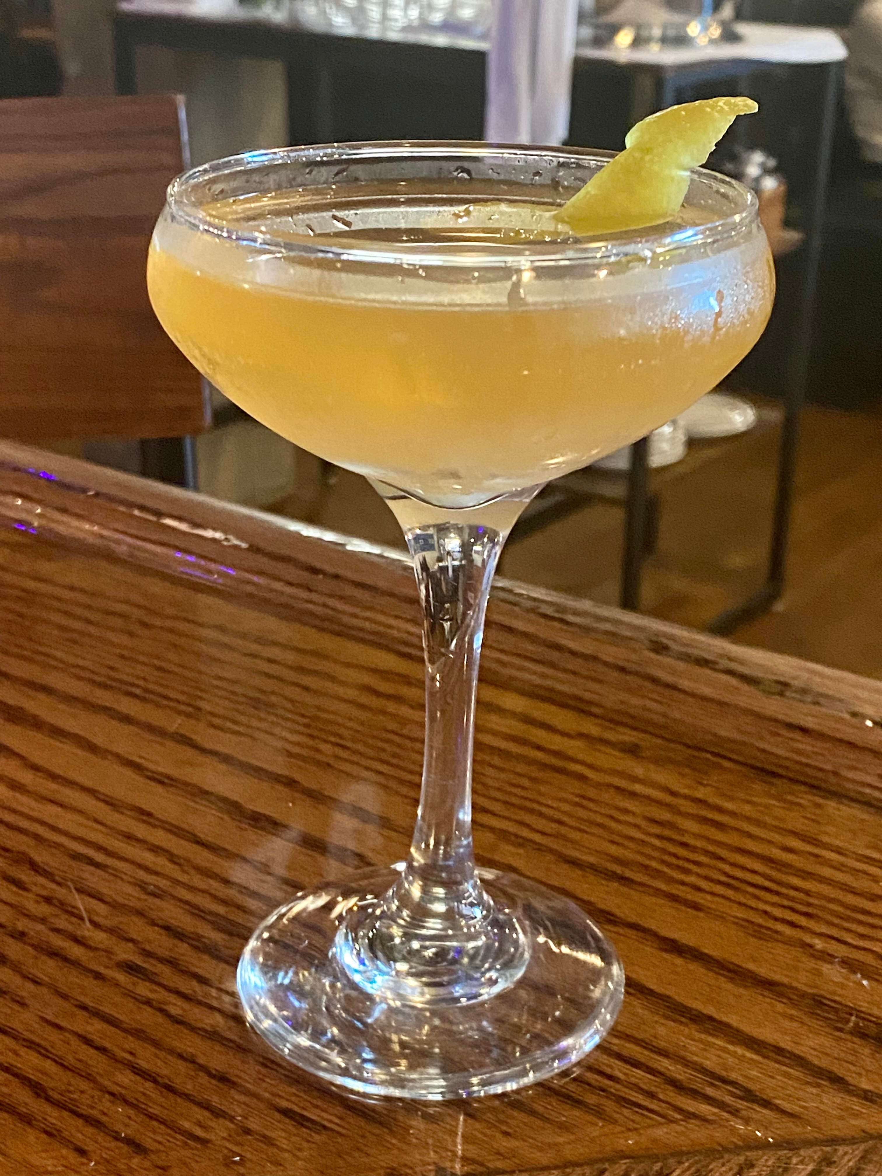 cocktail with lemon slice on bar