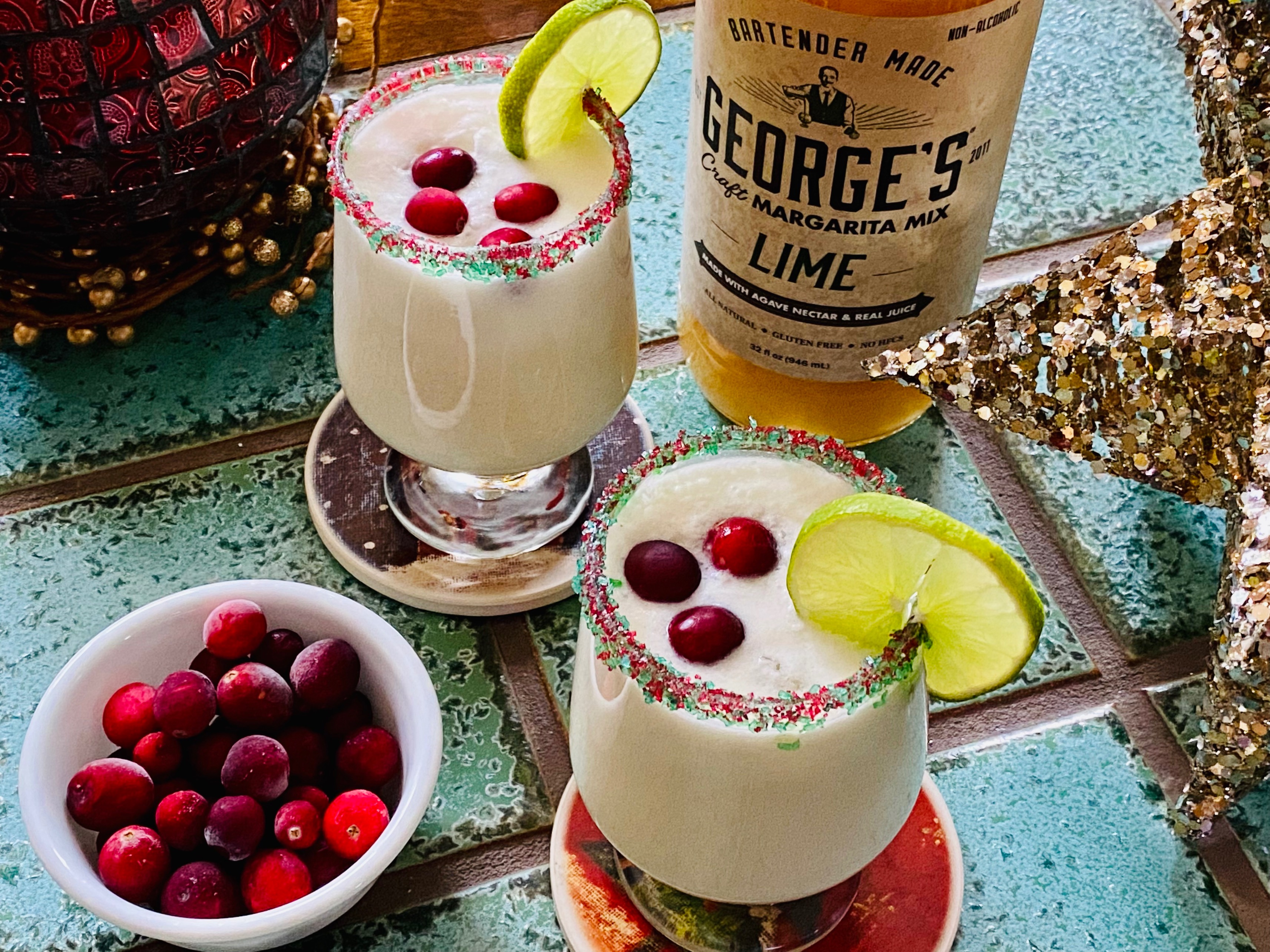 Christmas Margarita with lime margarita mix and coconut milk and cranberries