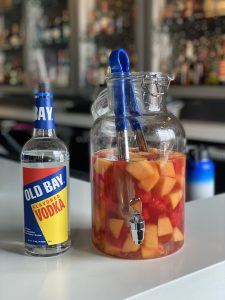 old bay vodka and vodka infused fruit in a container